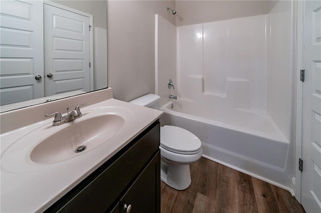 full bathroom with shower / bath combination, vanity, wood-type flooring, and toilet