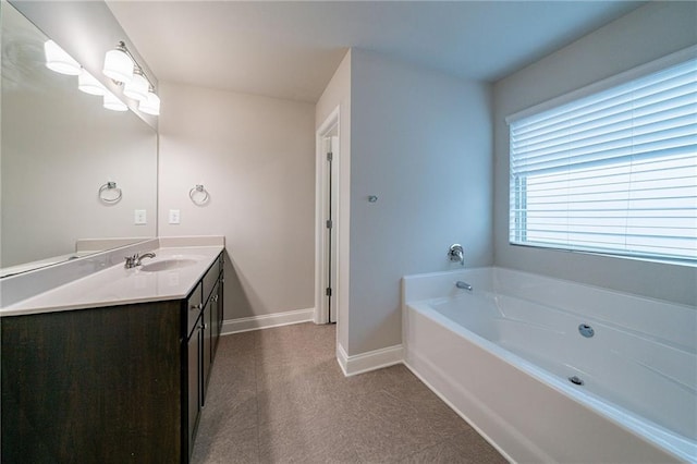 bathroom featuring vanity and a bath