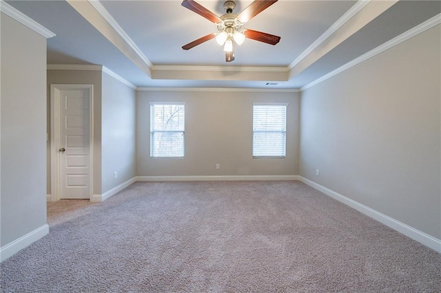 unfurnished room featuring a raised ceiling, light carpet, and ornamental molding