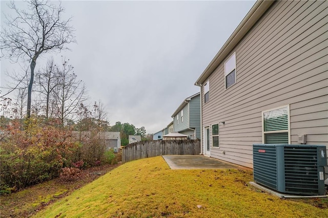 view of yard with central AC unit and a patio area