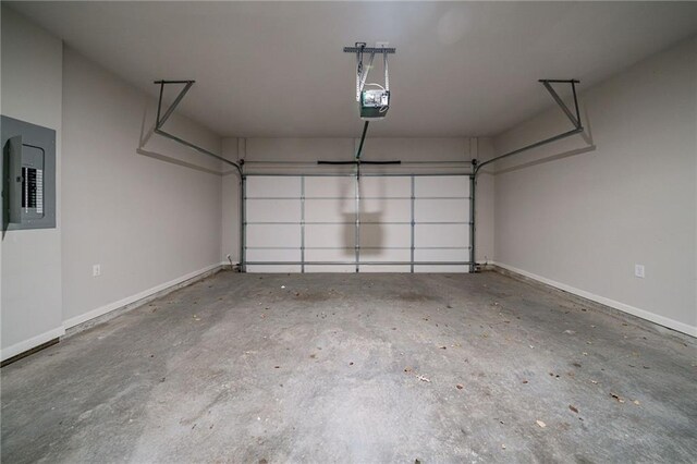 garage featuring electric panel and a garage door opener