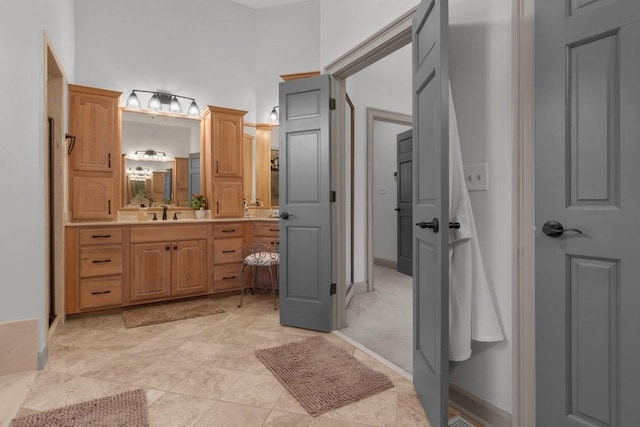 bathroom with vanity and a high ceiling