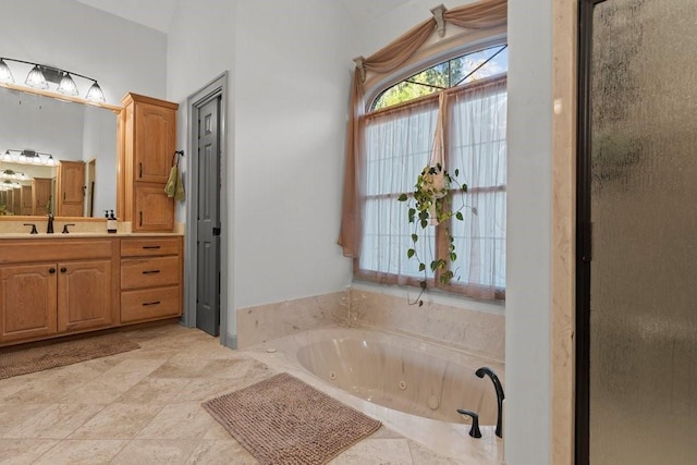 bathroom with vanity and shower with separate bathtub