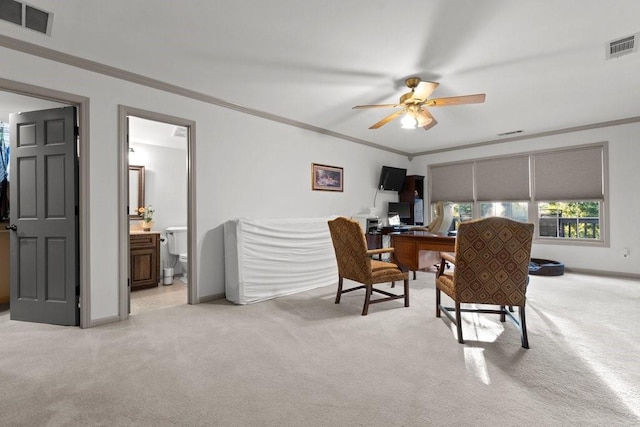 carpeted office space featuring ornamental molding and ceiling fan