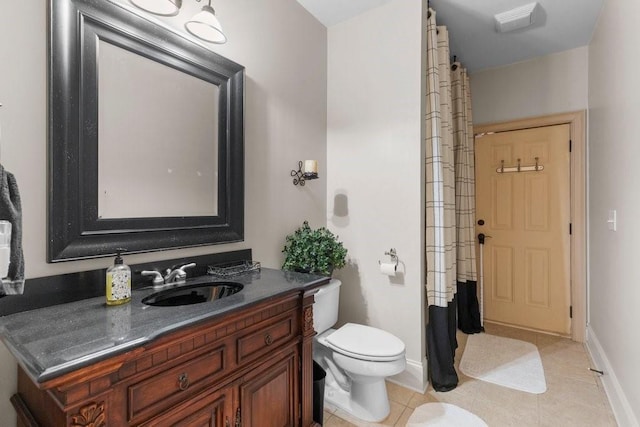 bathroom with vanity, tile patterned flooring, and toilet