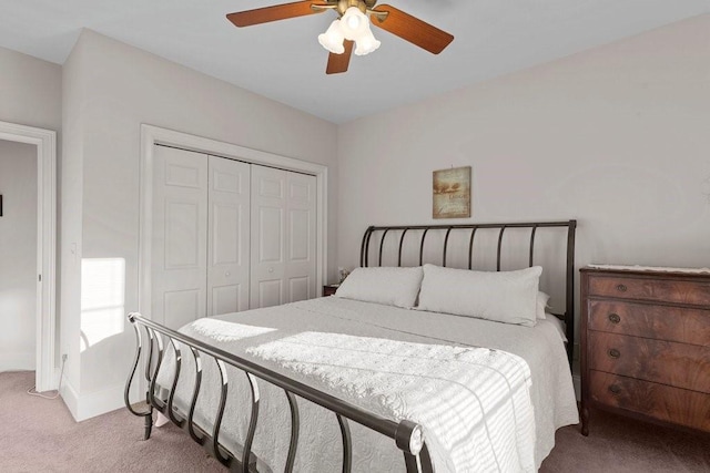 carpeted bedroom featuring a closet and ceiling fan