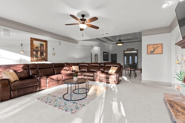 carpeted living room with ornamental molding and ceiling fan