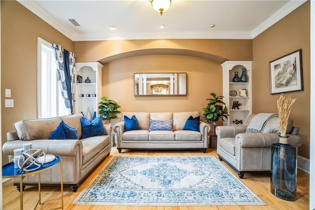 sitting room featuring ornamental molding and hardwood / wood-style floors