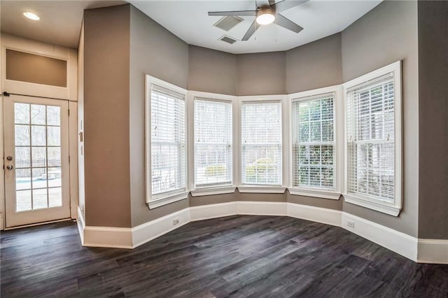 spare room with dark hardwood / wood-style floors and ceiling fan