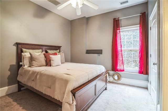 carpeted bedroom featuring multiple windows and ceiling fan