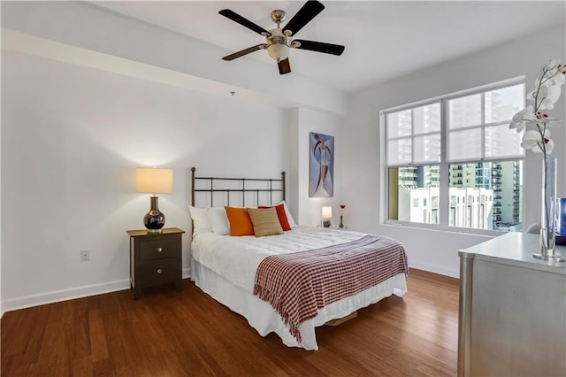 bedroom with ceiling fan and dark hardwood / wood-style flooring