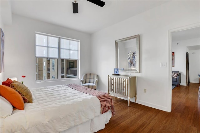 bedroom with dark hardwood / wood-style floors and ceiling fan