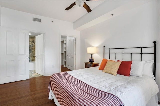 bedroom featuring ceiling fan, ensuite bathroom, and dark hardwood / wood-style flooring