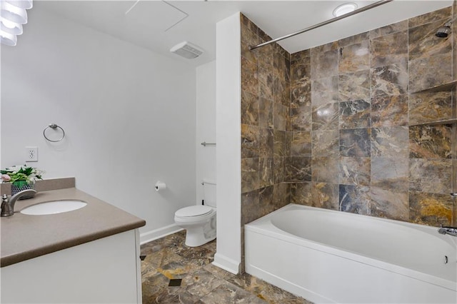 full bathroom featuring toilet, tiled shower / bath combo, and vanity