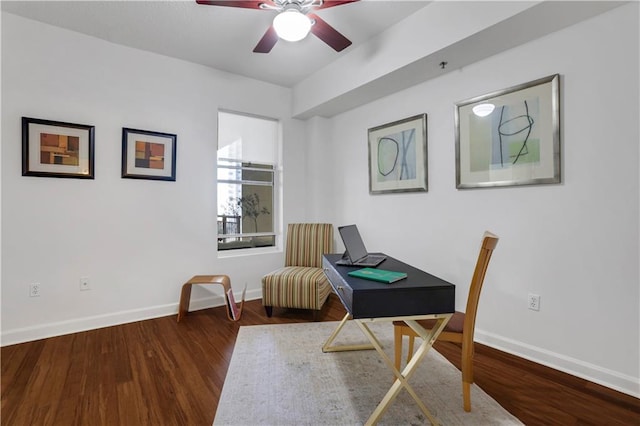 home office with dark wood-type flooring and ceiling fan