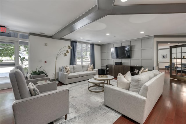 living room featuring beam ceiling and hardwood / wood-style flooring