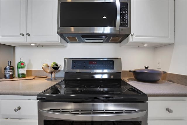 kitchen with appliances with stainless steel finishes and white cabinets