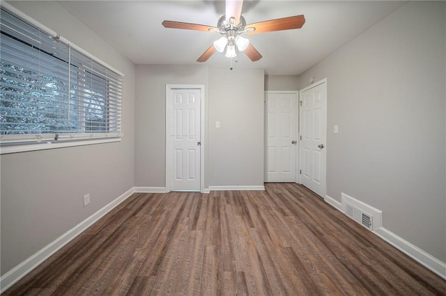 unfurnished bedroom with dark hardwood / wood-style floors and ceiling fan