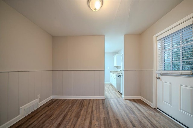 unfurnished room with wood-type flooring