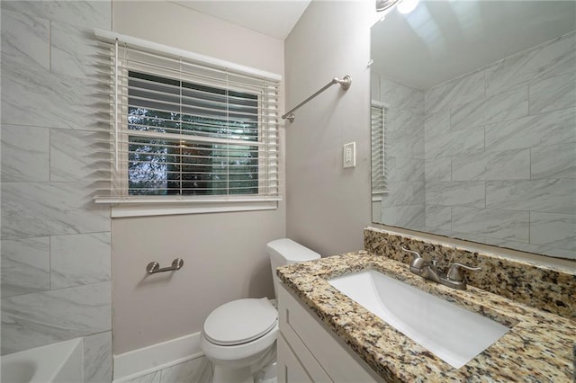 full bathroom with vanity, tiled shower / bath, and toilet