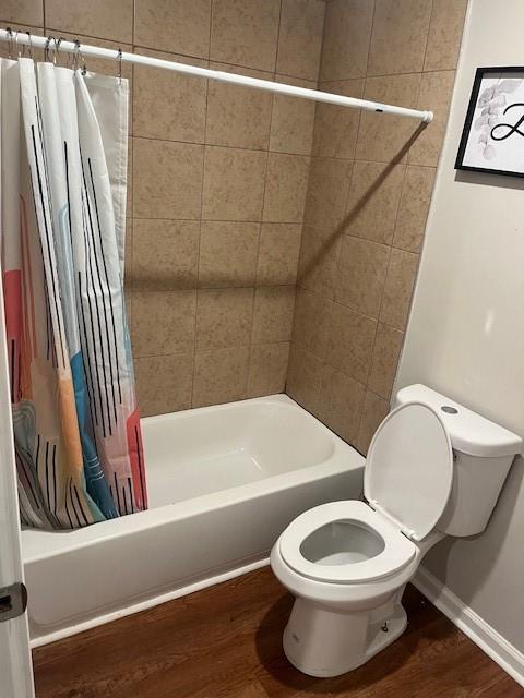 10 Rockmart Dr NW, Atlanta, GA 30314 - bathroom featuring toilet, shower / tub combo, wood finished floors, and baseboards
