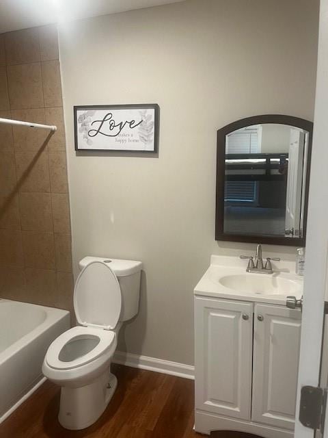 10 Rockmart Dr NW, Atlanta, GA 30314 - bathroom featuring toilet, vanity, wood finished floors, baseboards, and shower / tub combination