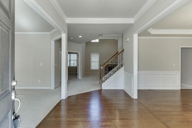 foyer entrance featuring ornamental molding and dark wood-type flooring