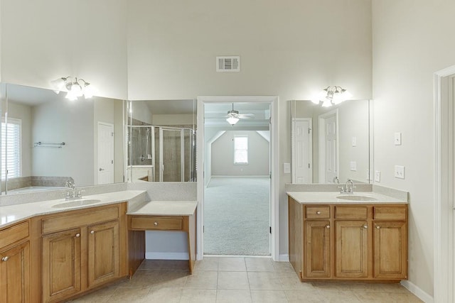 bathroom with tile patterned floors, ceiling fan, a healthy amount of sunlight, and an enclosed shower