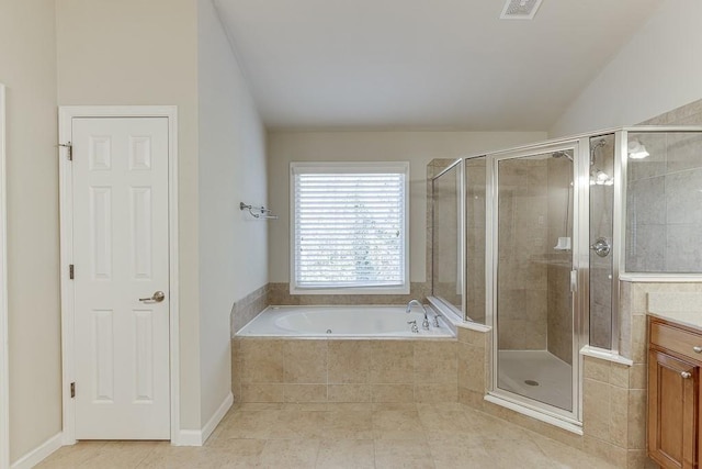 bathroom featuring tile patterned floors, vanity, plus walk in shower, and vaulted ceiling