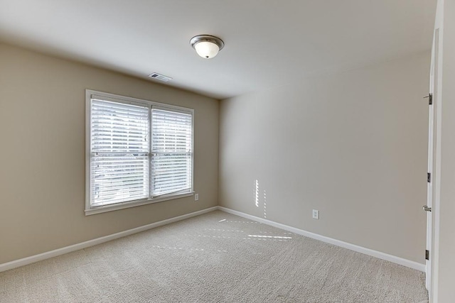 carpeted empty room with a wealth of natural light