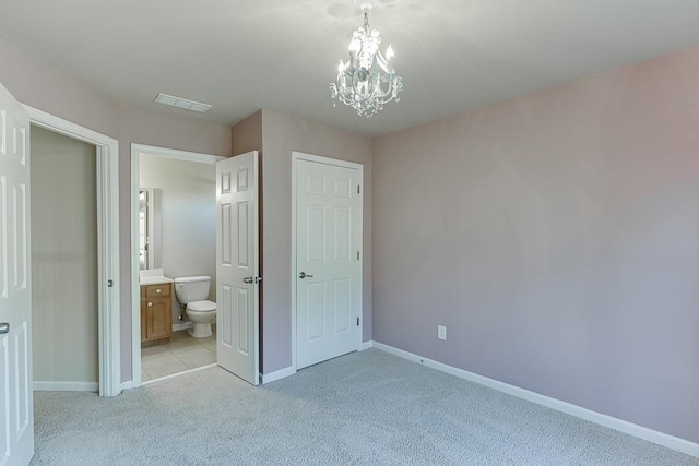 unfurnished bedroom with ensuite bathroom, light colored carpet, and a notable chandelier