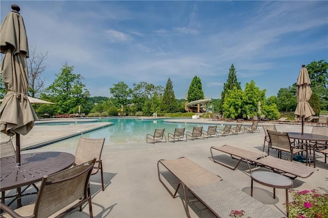 view of pool with a patio area and a water slide