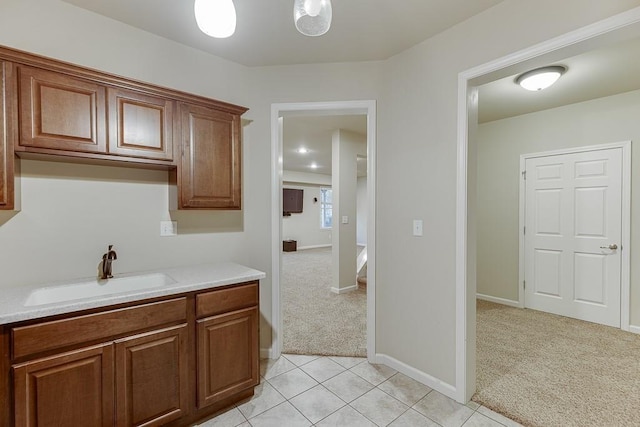 kitchen with light carpet and sink