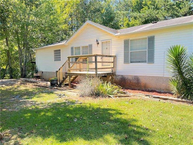 view of front of home featuring a front yard and a wooden deck