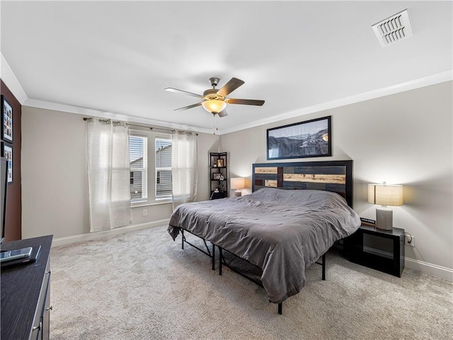 bedroom with visible vents, carpet flooring, baseboards, and ornamental molding