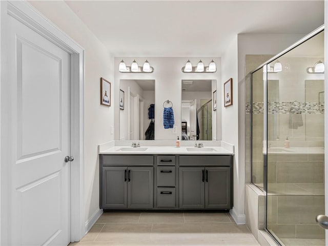 bathroom with a sink, double vanity, and a stall shower