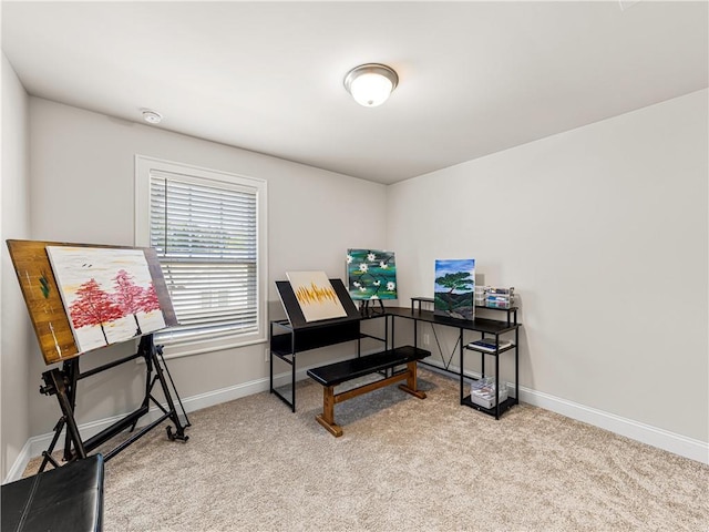 office area featuring baseboards and light colored carpet