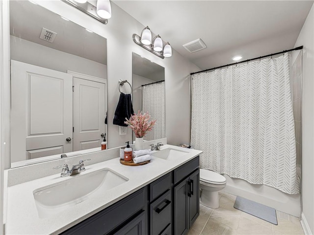 bathroom featuring toilet, a sink, and visible vents