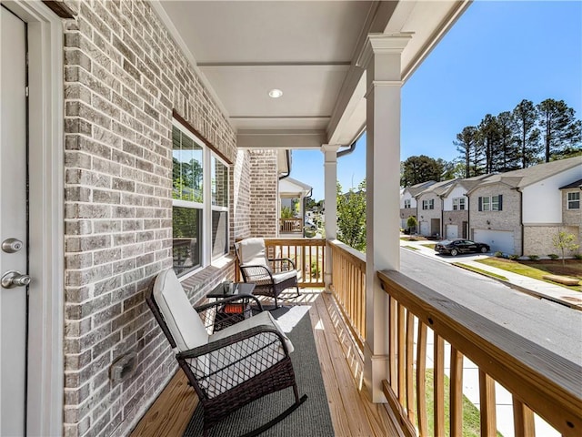balcony featuring a porch and a residential view
