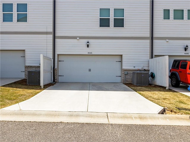 garage featuring driveway and central air condition unit