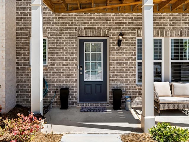 doorway to property featuring brick siding