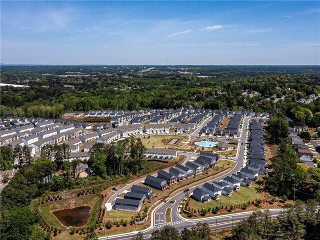 bird's eye view featuring a residential view and a wooded view