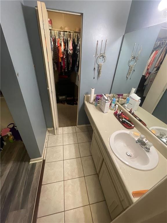 2009 Oak Park Ln, Decatur, GA 30032 - bathroom featuring a walk in closet, vanity, and tile patterned floors