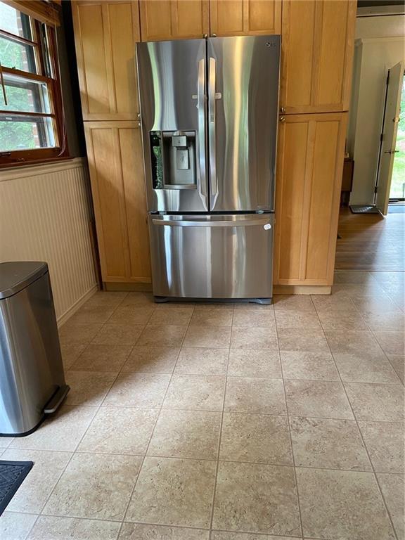406 S Hillcrest Dr SW, Marietta, GA 30064 - kitchen with stainless steel refrigerator with ice dispenser, a wainscoted wall, and brown cabinets