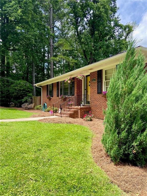 406 S Hillcrest Dr SW, Marietta, GA 30064 - view of front of house featuring a porch, brick siding, and a front yard