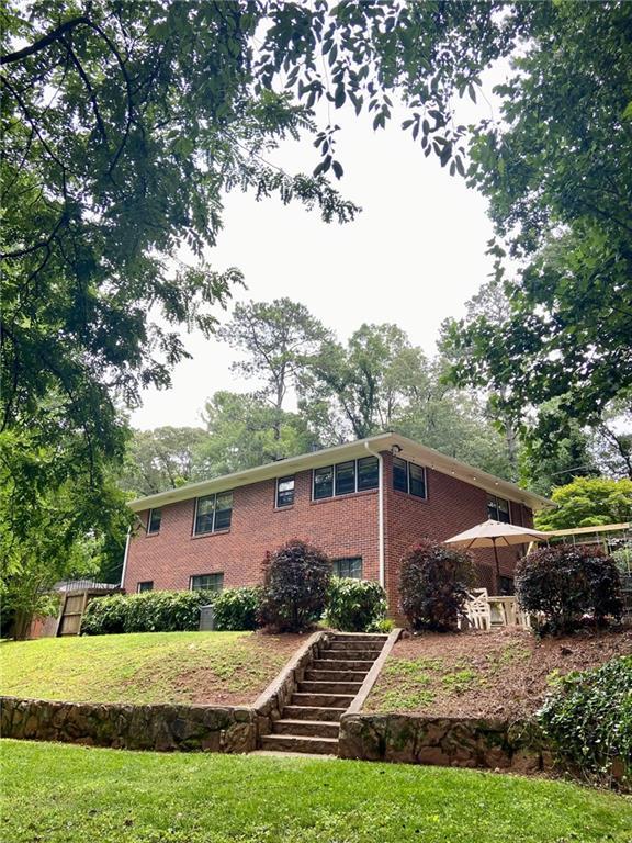 406 S Hillcrest Dr SW, Marietta, GA 30064 - view of front of house with stairway, a front yard, and brick siding