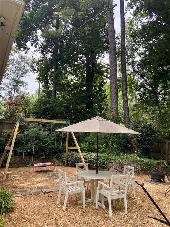 406 S Hillcrest Dr SW, Marietta, GA 30064 - view of patio with a playground, a fire pit, and outdoor dining area