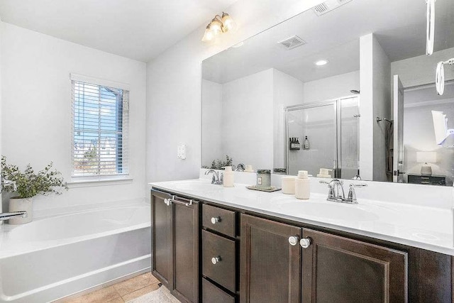 bathroom with tile patterned flooring, vanity, and shower with separate bathtub