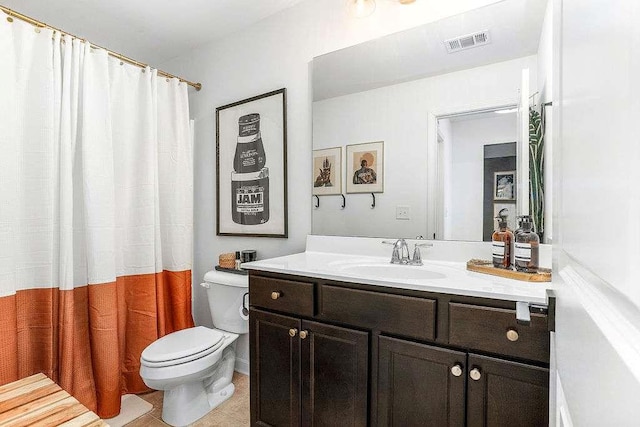 bathroom featuring tile patterned floors, vanity, and toilet