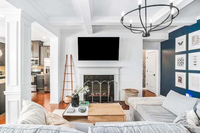 living room featuring coffered ceiling, beamed ceiling, a notable chandelier, hardwood / wood-style flooring, and a high end fireplace